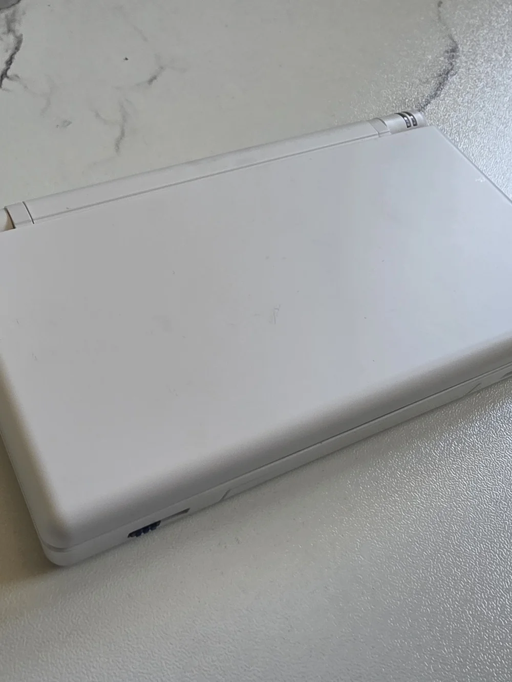 Nintendo White Handheld Console with Blue Controls